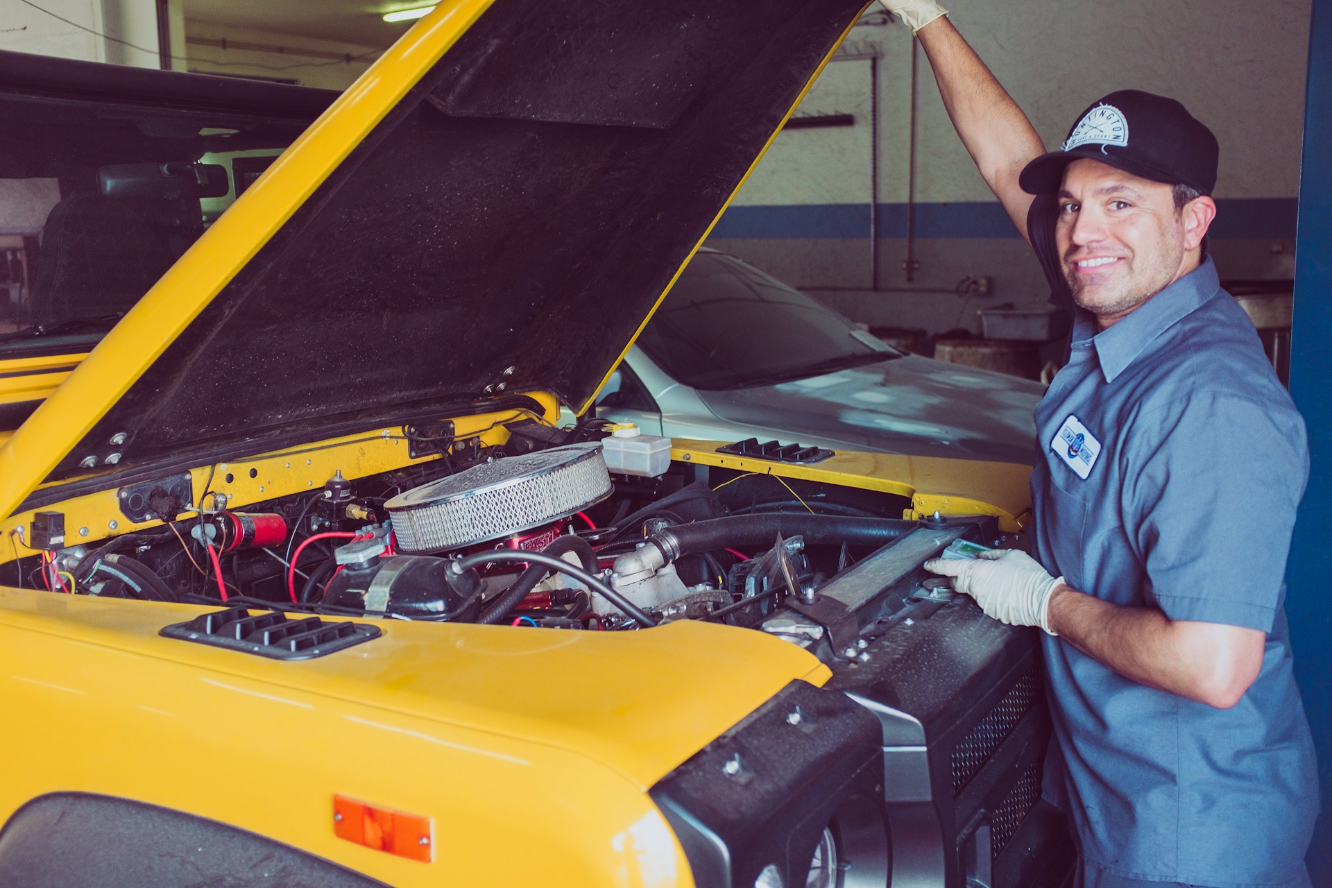 Tom, owner of Tom's Auto Repair, smiling in the shop